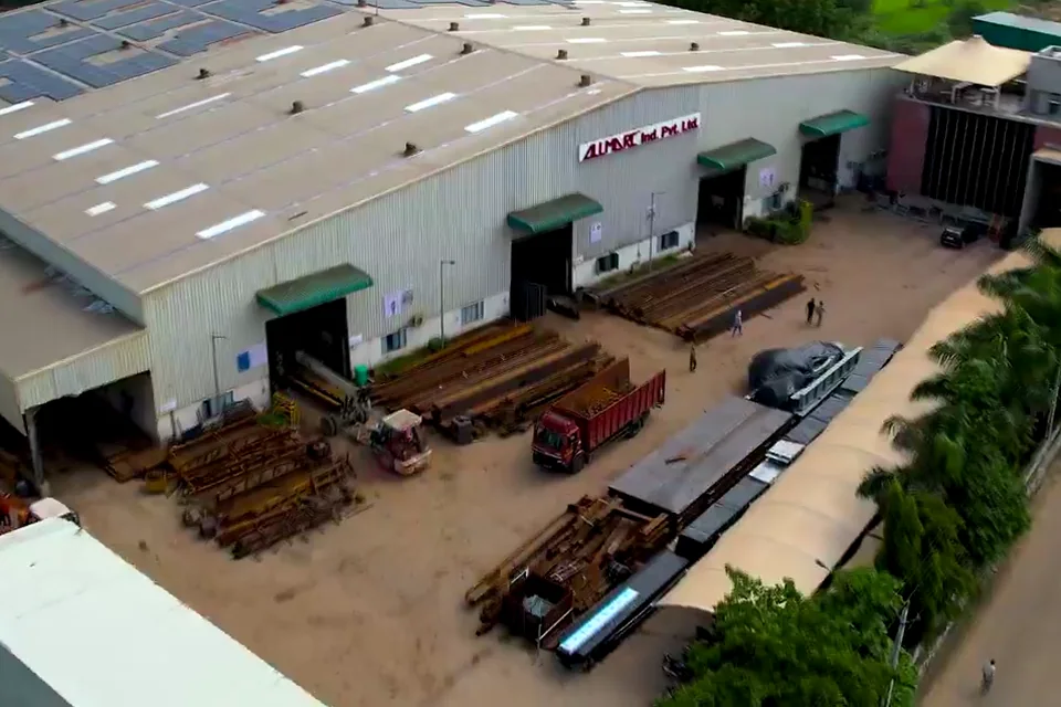 Unit 1 at Kanbha from the air: the shed with the Allmarc sign and steel sections stacked in the yard