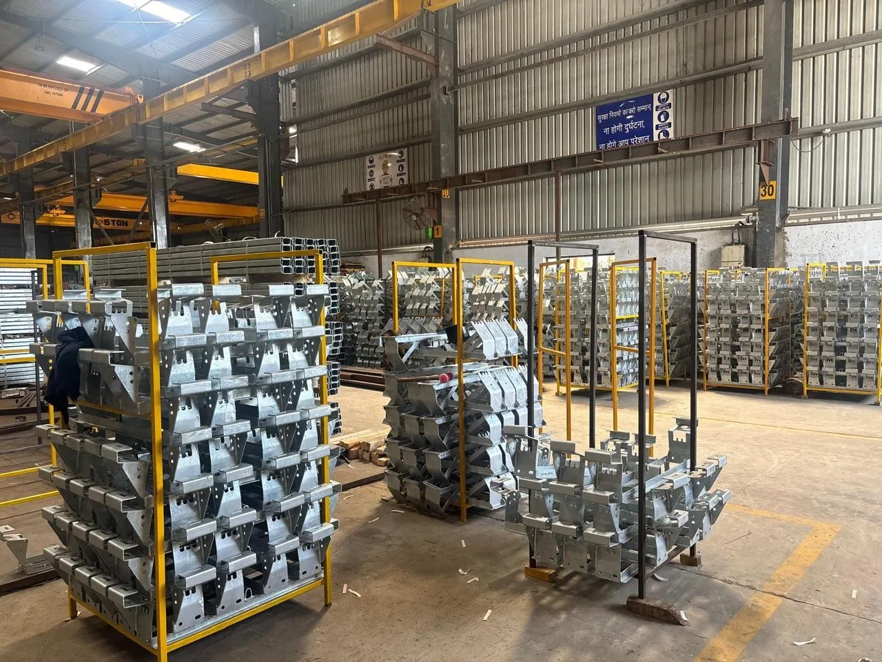 Conveyor brackets for a tunnel boring machine, staged in racks